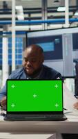 Vertical Factory engineers use green screen laptop to check PV materials parameters, improving solar panel durability. Researcher develop efficient sustainable energy solutions using mockup notebook, camera A video