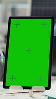 Vertical Industrial plant manager using isolated screen tablet during business meeting. Factory executive working on pitch for investors using mockup device, talking about production automation video