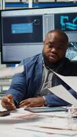 Vertical Factory engineering team look at assembly lines designs, working to increase energy output. Photovoltaics plant experts brainstorm innovative solar cell prototypes, looking over schematics, camera A video