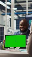 Vertical Shareholders in photovoltaics plant analyze market trends on isolated screen tablet to determine investment strategy. Managers look at data on mockup device, expanding factory production, camera A video