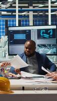 Vertical Factory manager presents business models to investors, highlighting innovative strategies for expanding production. Shareholders discuss integrating automation technology in industrial plant, camera A video