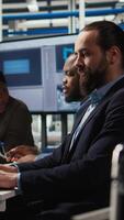 Vertical Factory engineering team using laptop to refine designs for increased energy output using collected data. Photovoltaics plant specialists design innovative solar cell prototypes on notebook, camera A video