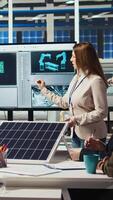 Vertical Scientists conduct experiments on PV materials to improve solar panel efficiency. Photovoltaics factory research and development department experts working on renewable energy solutions, camera A video