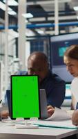 Vertical Photovoltaics plant specialists design solar cell prototypes on mockup device. Factory engineers using isolated screen tablet to refine designs for increased energy output using data, camera A video