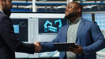 Solar panel factory manager shaking hands with investor interested in manufacturing process. Man greeting shareholder visiting photovoltaics plant to see production growth data, doing handshake, camera B video