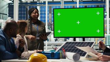 Researchers analyze solar cell prototypes to optimize energy production, looking at isolated screen monitor. Solar panels plant experts develop innovative manufacturing tech using chroma key display video