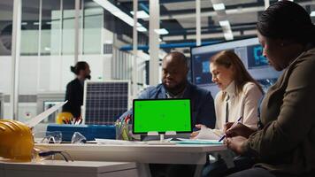 Factory engineer tripping while study assembly lines schematics, refining production layouts using green screen tablet. Experts outlining industrial plant configurations using mockup device, camera A video