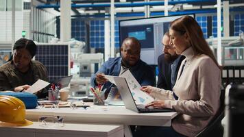 Factory manager looking over paperwork files, developing business model, expanding production. Employee reading documentation files, integrating automation technology in industrial plant, camera A video