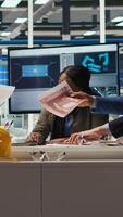 Vertical Industrial plant management looking over paperwork and schematics. Factory executives meet with investors to discuss integration of automation technology in production, camera A video