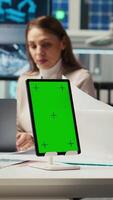 Vertical Managers in office reviewing solar technology reports on isolated screen tablet. Shareholders using chroma key device, discussing investment opportunities in green energy production, camera B video