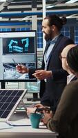 Vertical Research and development team analyzes solar cell prototypes to optimize energy conversion rates. Solar panels plant experts developing innovative manufacturing techniques, camera A video