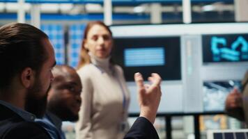 Shareholders meeting in photovoltaics plant, analyzing market trends to determine investment strategies. Managers brainstorming innovations, expanding factory production capabilities, camera B video