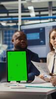 Vertical Managers in office reviewing solar technology reports on isolated screen tablet. Shareholders using chroma key device, discussing investment opportunities in green energy production, camera A video