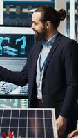Vertical Research and development team analyzes solar cell prototypes to optimize energy conversion rates. Solar panels plant experts developing innovative manufacturing techniques, camera B video