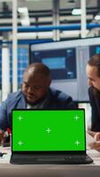 Vertical Factory engineers using green screen laptop to refine designs for increased energy output using data. Photovoltaics plant specialists design solar cell prototypes on chroma key notebook, camera A video
