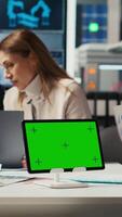 Vertical Factory engineer tripping while study assembly lines schematics, refining production layouts using green screen tablet. Experts outlining industrial plant configurations using mockup device, camera B video