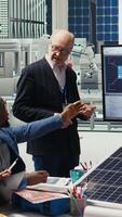 Vertical Management executives and investors in photovoltaics plant analyzing market trends to determine investment strategies for expanding solar energy production capabilities, camera A video