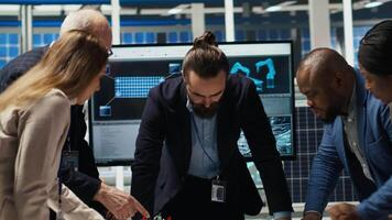 Factory management looking over schematics, working together to expand production. Industrial plant executives doing brainstorming, discussing over blueprint of facility layout, camera B video