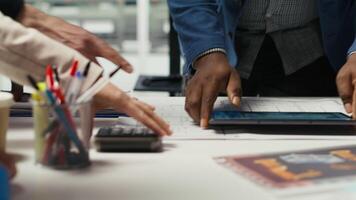 Factory experts designing assembly facility production lines in tablet CAD program. Industrial plant employees using software on device to optimize facility production layouts video