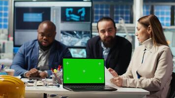 Factory engineers use green screen laptop to check PV materials parameters, improving solar panel durability. Researcher develop efficient sustainable energy solutions using mockup notebook, camera B video