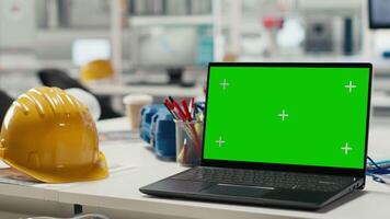Green screen laptop used to adjust photovoltaics factory system parameters. Mockup notebook in office used for optimizing energy supply in solar panel manufacturing plant video