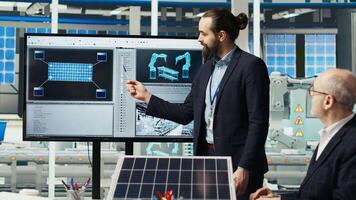 Research and development team analyzes solar cell prototypes to optimize energy conversion rates. Solar panels plant experts developing innovative manufacturing techniques, camera B video