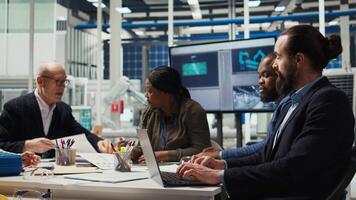 Industrial plant manager typing on laptop, preparing paperwork before business meeting. Factory executives working on pitch for investors using notebook, automating production, camera A video