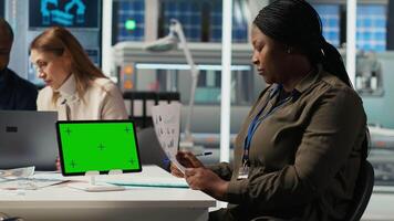 Factory engineer tripping while study assembly lines schematics, refining production layouts using green screen tablet. Experts outlining industrial plant configurations using mockup device, camera B video