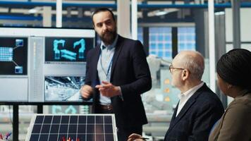 Scientists in photovoltaics factory experimenting with advanced PV materials to improve solar panel durability and efficiency for long term sustainable energy solutions, camera B video