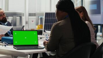 Researchers analyze solar cell prototypes using green screen laptop to optimize energy production. Solar panels plant experts developing innovative manufacturing tech using mockup notebook video