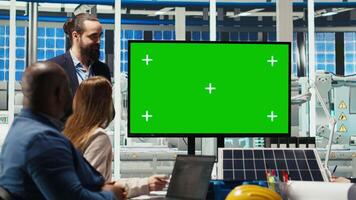 Factory engineers use isolated screen monitor to check solar panel materials parameters, improving durability. Researchers develop sustainable energy solutions, looking at chroma key display, camera B video