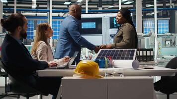 Investors shaking hands, meeting to talk about automation strategies for solar panel production scaling. Shareholders doing greeting handshake in photovoltaics factory, camera A video