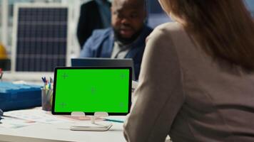 Shareholders in photovoltaics plant analyze market trends on isolated screen tablet to determine investment strategy. Managers look at data on mockup device, expanding factory production, camera B video