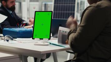Industrial plant researchers work on breakthroughs in durability and performance using isolated screen tablet, close up. Factory scientists use chroma key device to test materials for solar panels video