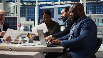 Factory manager developing lucrative business model using laptop, expanding production. Man works on integrating automation technology in industrial plant, looking at equipment on notebook, camera A video