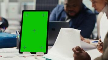 Industrial plant manager using isolated screen tablet during business meeting. Factory executive working on pitch for investors using mockup device, talking about production automation video