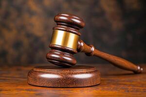 Wooden gavel on a wooden table with a dark background photo