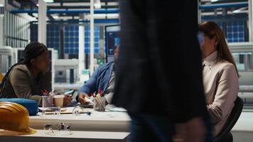 Factory research and development scientists use laptop to test materials for next generation solar panels. Industrial plant researchers work on breakthroughs in durability and performance, camera A video