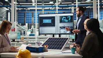 Research and development team analyzes solar cell prototypes to optimize energy conversion rates. Solar panels plant experts developing innovative manufacturing techniques, camera A video