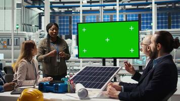 Management executives look at automation strategies for solar panel production scaling on green screen monitor. Businesspeople in factory do financial investments, looking at mockup display, camera A video