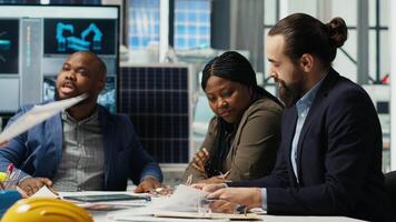 Factory manager presents business models to investors, highlighting innovative strategies for expanding production. Shareholders discuss integrating automation technology in industrial plant, camera B video