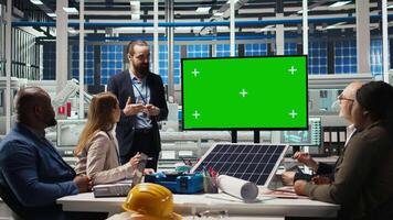 Factory engineers use isolated screen monitor to check solar panel materials parameters, improving durability. Researchers develop sustainable energy solutions, looking at chroma key display, camera A video