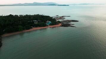 Aerial view of a small island beach with tropical landscape and a hidden paradise, showcasing pristine sandy beaches, palm trees and small islands on the stunning ocean waters. Exotic panorama. video