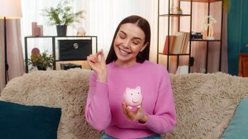 Woman counting small coins carefully placing them into piggy bank saving investing future finances video