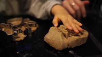 Little girl picking up dough leftovers near cookie cutters video