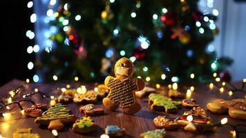 Gingerbread man in a mask on a table among cookies and glowing garlands video