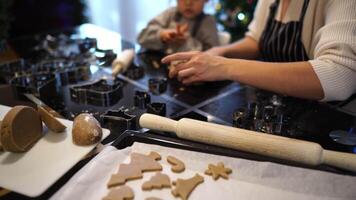 Mom with a little daughter cut out cookies from the dough with die-cuts video