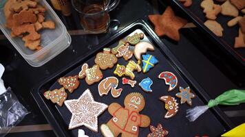 Christmas cookies decorated with colorful icing ornaments lie on a tray video