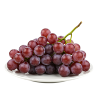 A bunch of red grapes arranged on a white plate with a plain contrasting color in the distance transparent background png