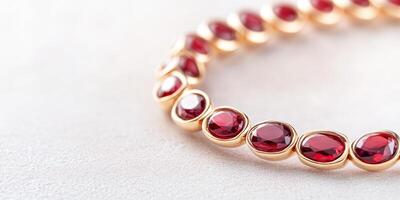 Close-up view of a dark cherry ring and bracelet, highlighting intricate gold accents and textures photo